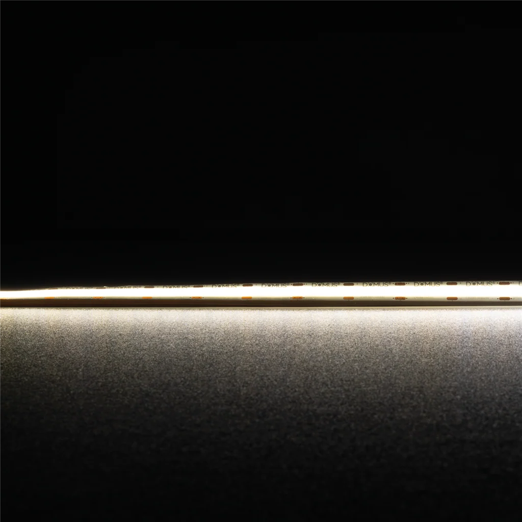 Thin metallic rod on a reflective surface High CRI90 Domus Plex COB LED strip for premium illumination with a dark background