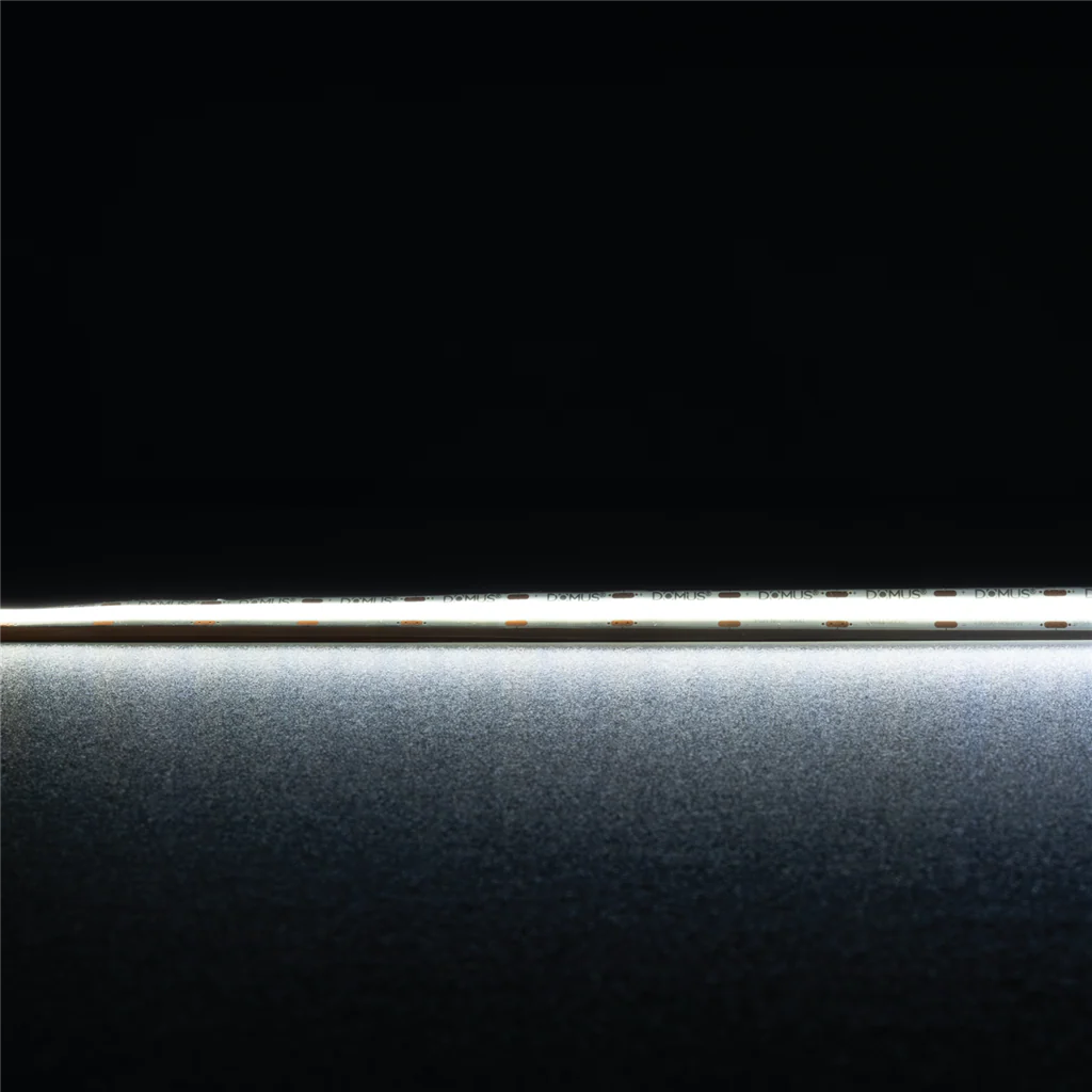 Flexible IP54 COB LED tape light by Domus Plex LED strip light on a black background