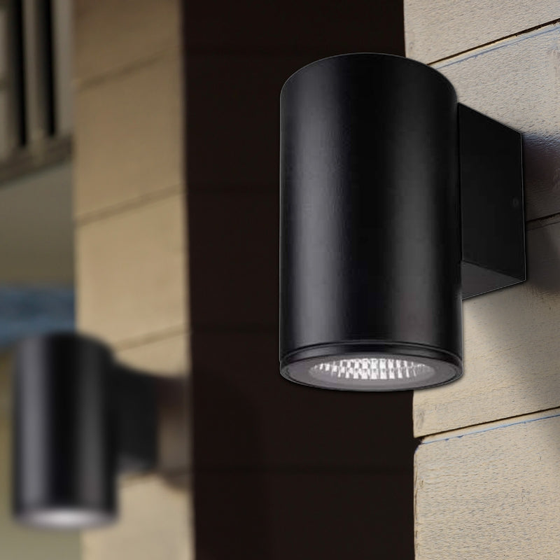 Black outdoor wall light fixture on a building exterior.
