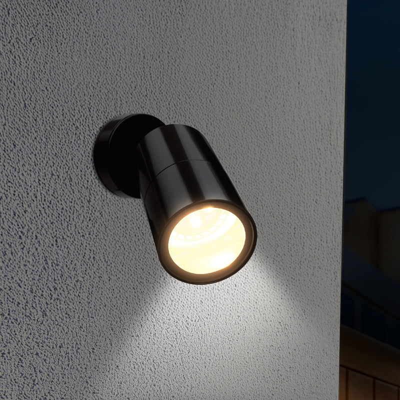 Black outdoor wall light fixture on a textured gray wall