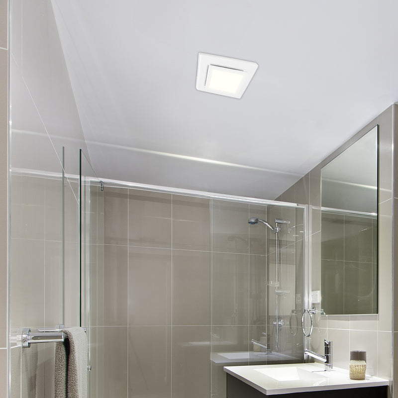 Modern bathroom with glass shower enclosure, sink, and mirror.