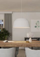 Dining room with wooden table, chairs, and a pendant light.