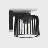 Ceiling light fixture with black cylindrical design on a white background