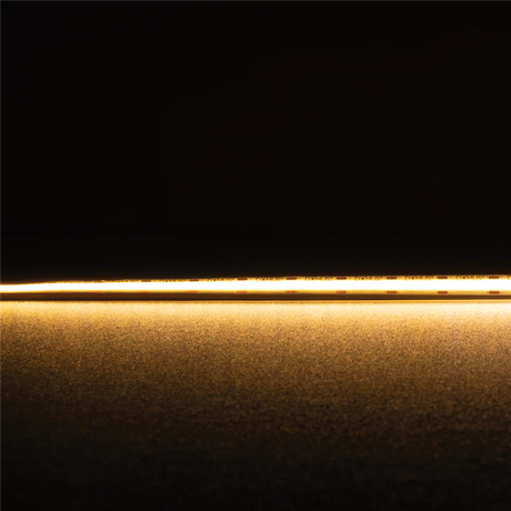 Thin gold strip Domus Plex COB 5 IP54 LED strip 24V 1 meter lighting on a black background
