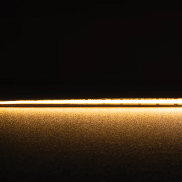 Thin gold strip Domus Plex COB 5 IP54 LED strip 24V 1 meter lighting on a black background