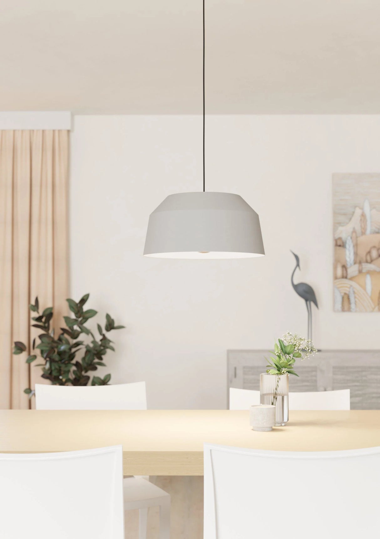Modern dining room with a gray pendant light, white chairs, and decorative elements.