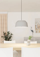 Modern dining room with a gray pendant light, white chairs, and decorative elements.