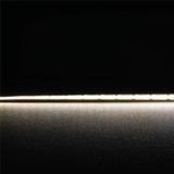 Thin metallic rod on a reflective surface High CRI90 Domus Plex COB LED strip for premium illumination with a dark background