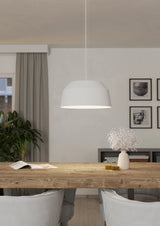 Dining room with wooden table, white chairs, and a modern light fixture.