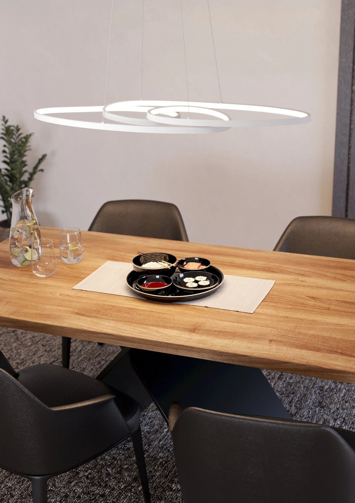 Dining table with chairs and a modern pendant light in a room.