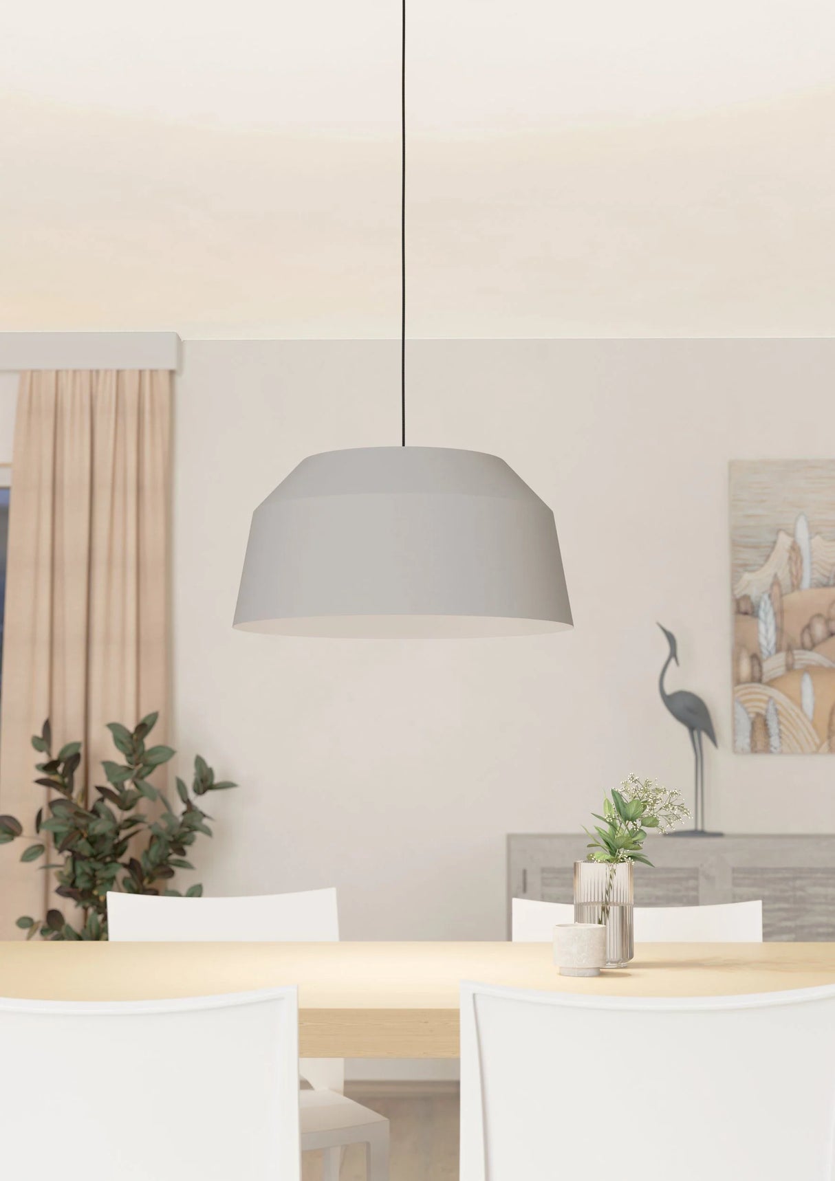 Modern dining room with a gray pendant light, table, chairs, and decorative elements.