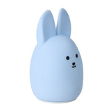 Blue rabbit-shaped night light on a white background