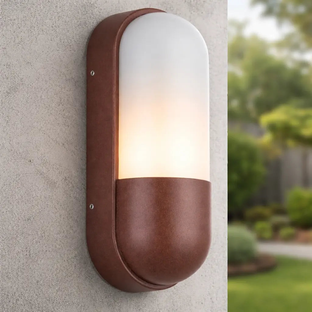 Brown outdoor wall light fixture on a concrete wall with a garden background