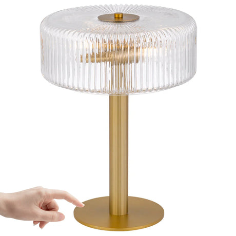 Telbix Brizo table lamp in antique brass showing how easily it can be switched on with a tap on the base.