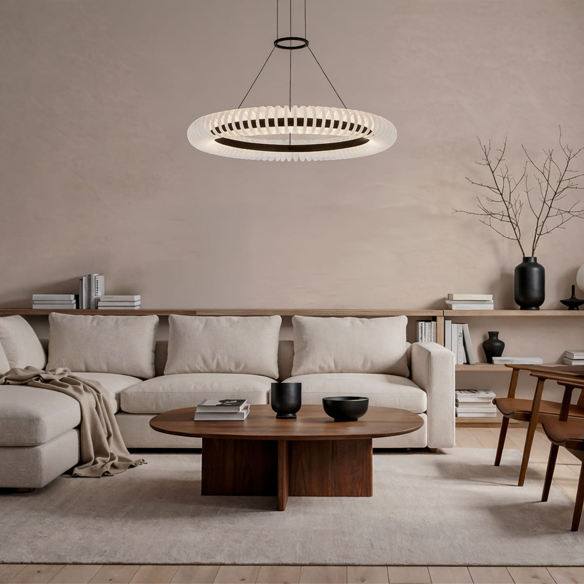 Modern living room with a beige sofa, wooden coffee table, and pendant light.