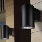 Black outdoor wall light fixture on a building exterior.