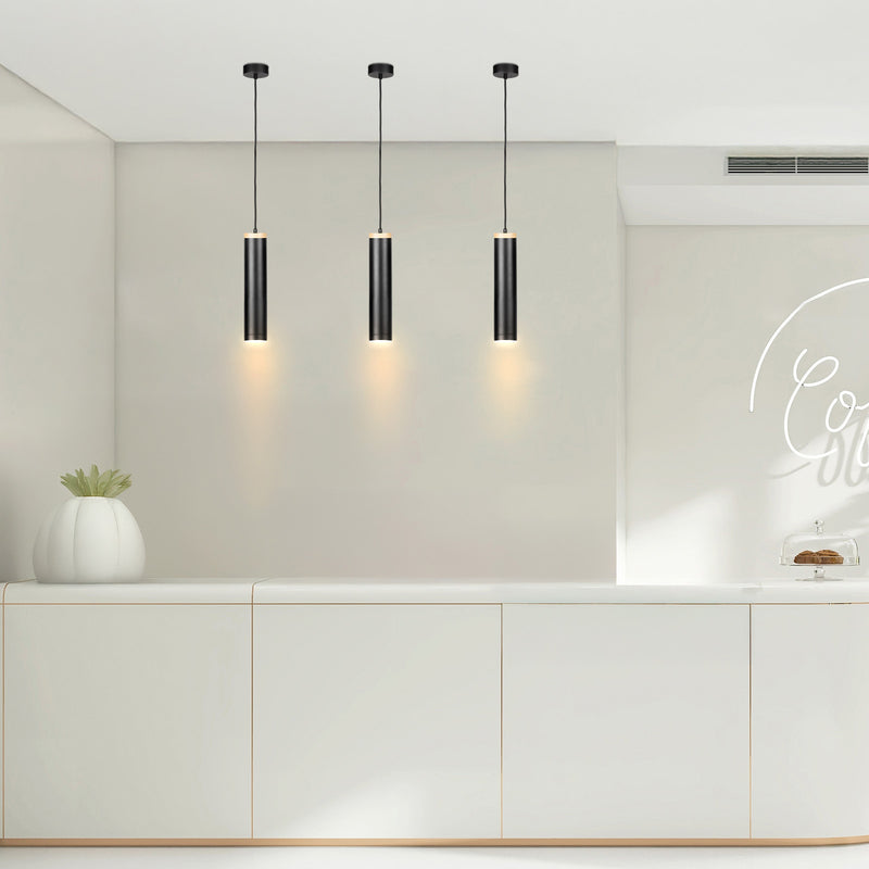Modern kitchen with three pendant lights hanging above a countertop.