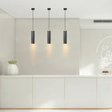 Modern kitchen with three pendant lights hanging above a countertop.