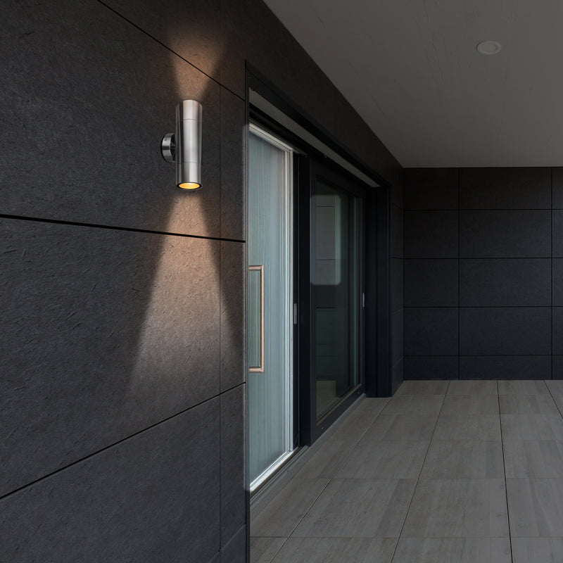Modern outdoor wall light fixture on a dark tiled wall.