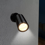 Black outdoor wall light fixture on a textured gray wall