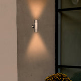 Modern wall-mounted outdoor light fixture on a concrete wall with a soft glow.