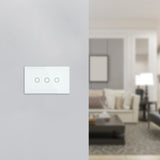 Smart home control panel on a wall with a blurred living room in the background