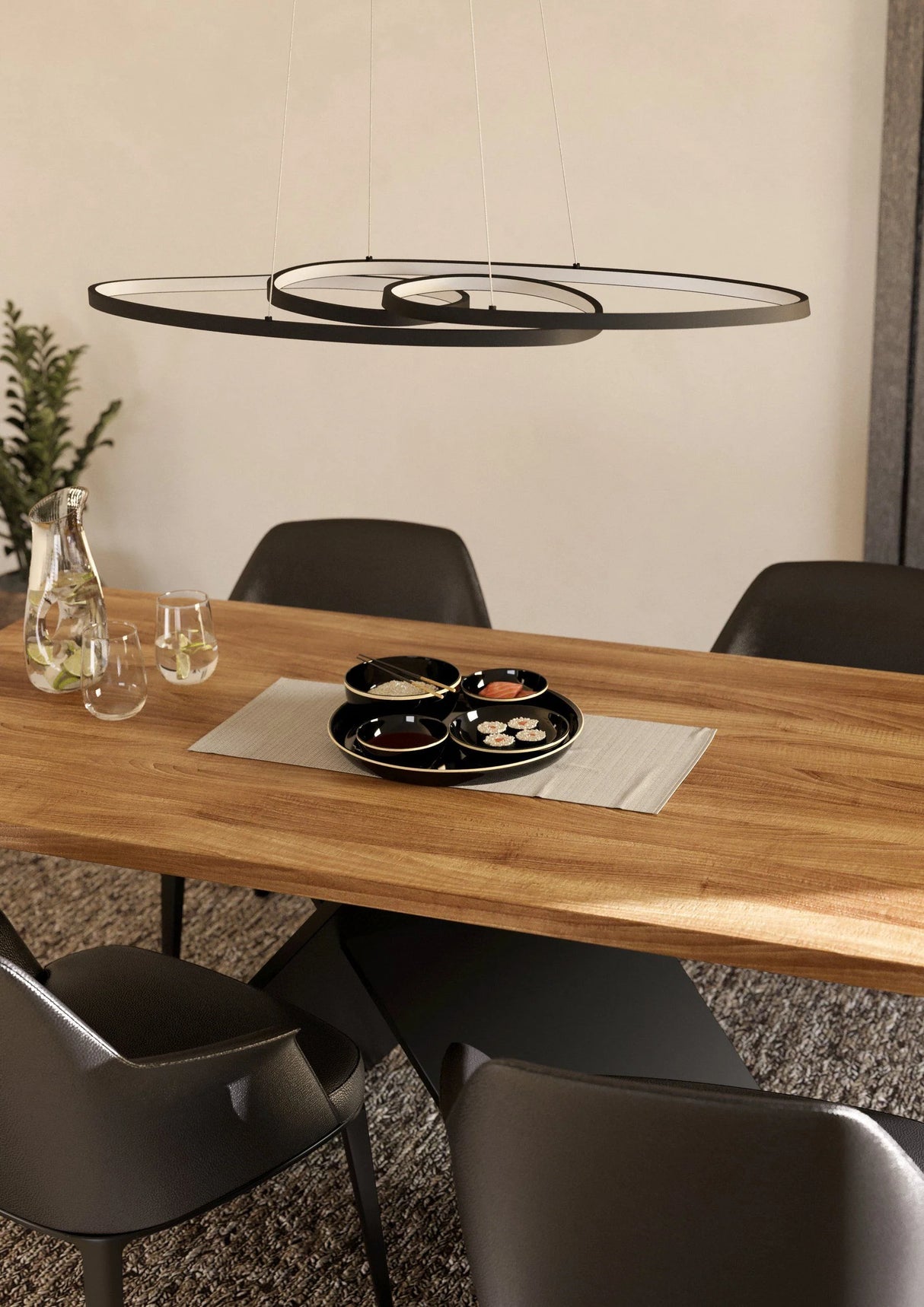 Dining table with chairs and a modern pendant light in a room.